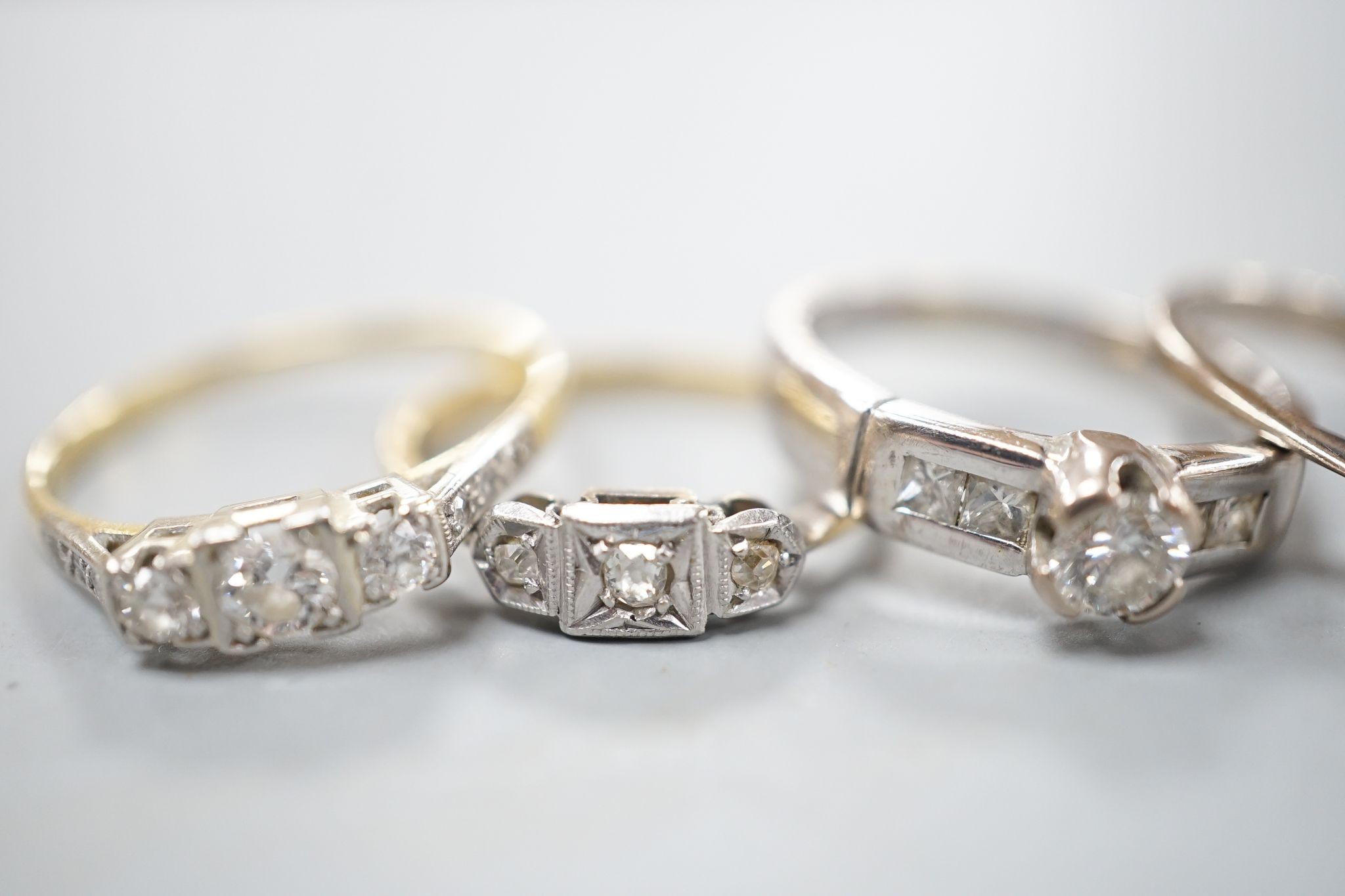 Four assorted diamond dress rings including two 18ct and two white metal, gross 10 grams
